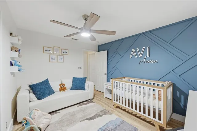 a bedroom with furniture and a large window