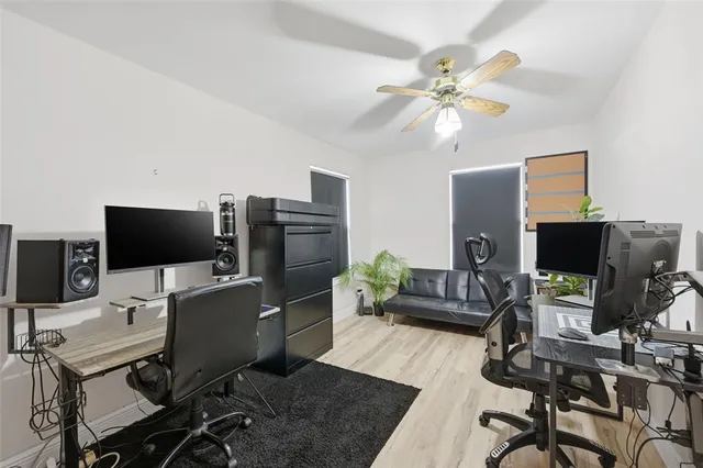 a view of a workspace with furniture and a window