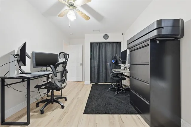 a view of a workspace with furniture and a window