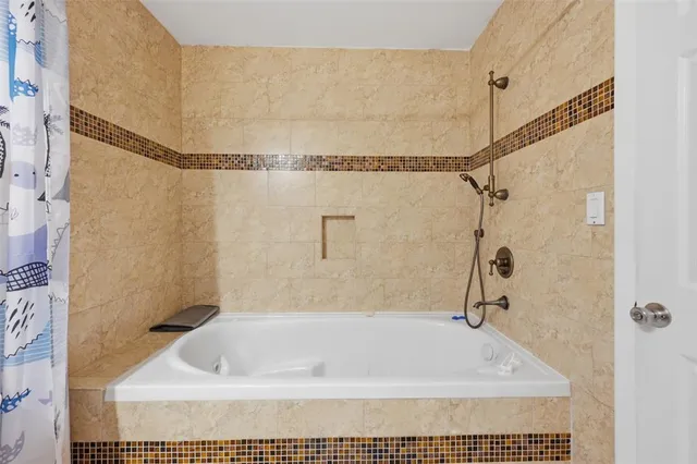 a bath tub sitting next to a shower