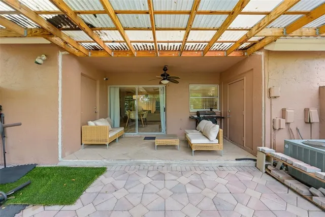 a building outdoor space with patio furniture and potted plants