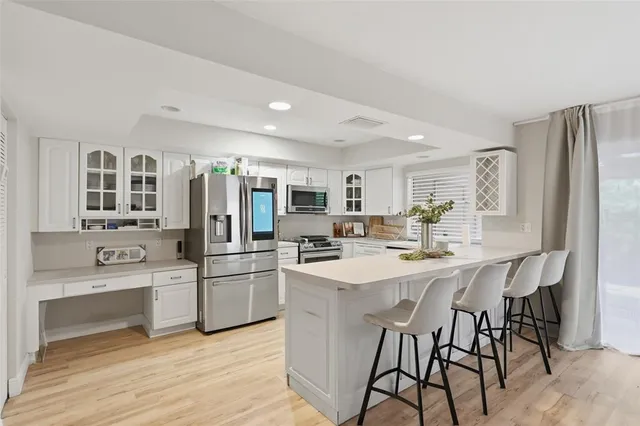 a kitchen with stainless steel appliances a stove a sink dishwasher and a refrigerator