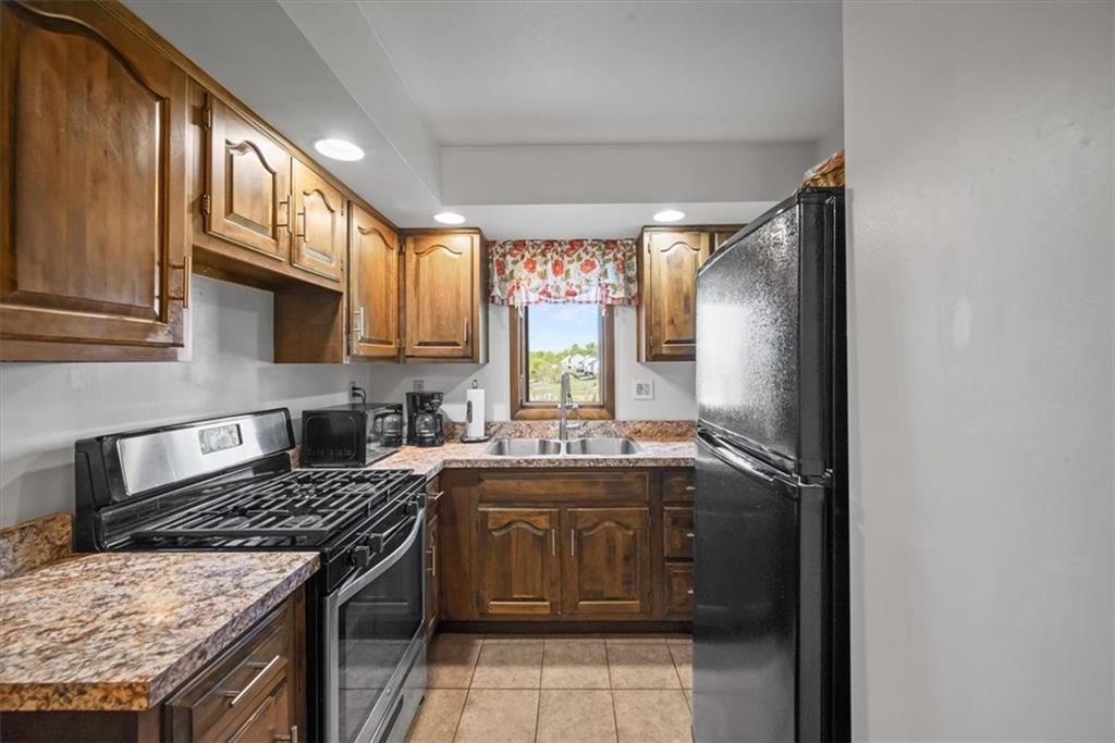 3616 New Texas Road Pittsburgh, PA 15239 - Photo 12 of 25 a kitchen with a stove sink and cabinets