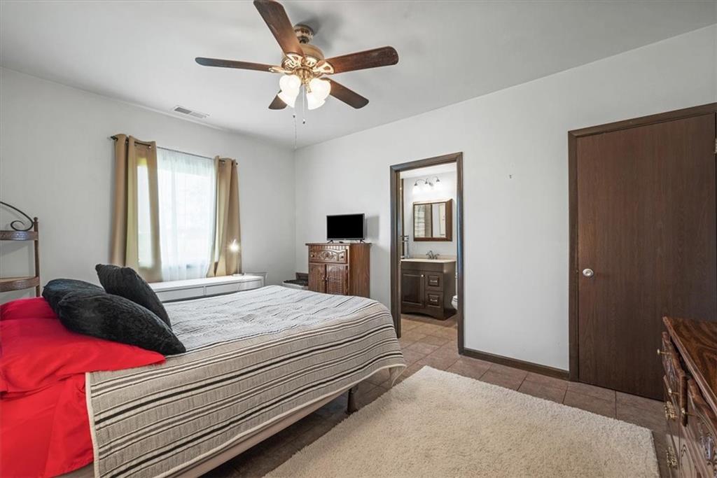 3616 New Texas Road Pittsburgh, PA 15239 - Photo 13 of 25 a bedroom with a bed and a chandelier