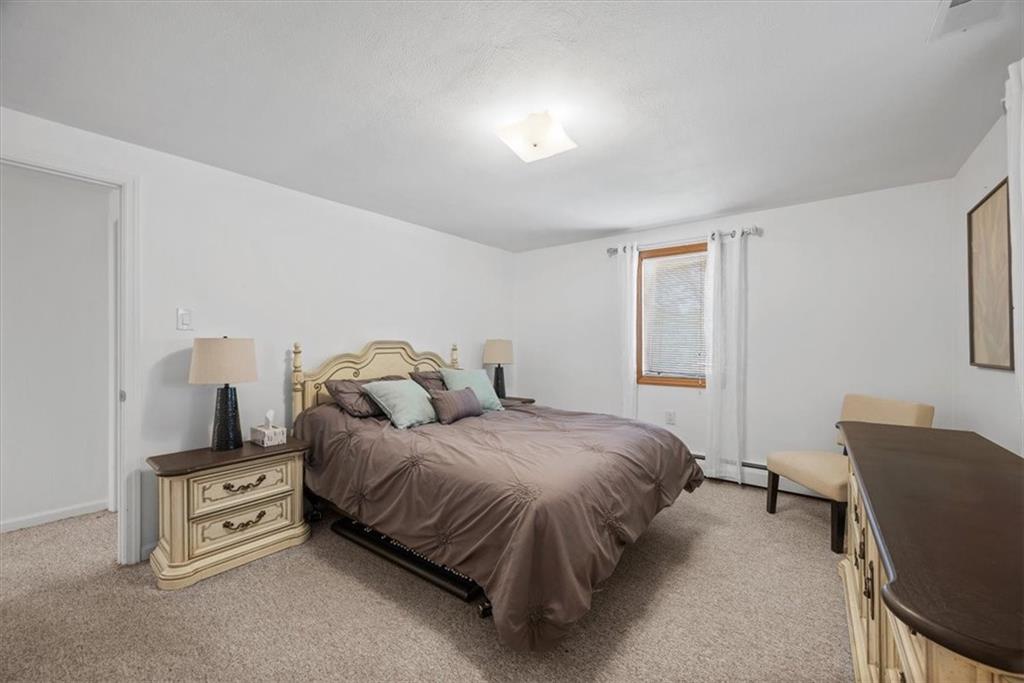 3616 New Texas Road Pittsburgh, PA 15239 - Photo 14 of 25 a bedroom with a bed and chair