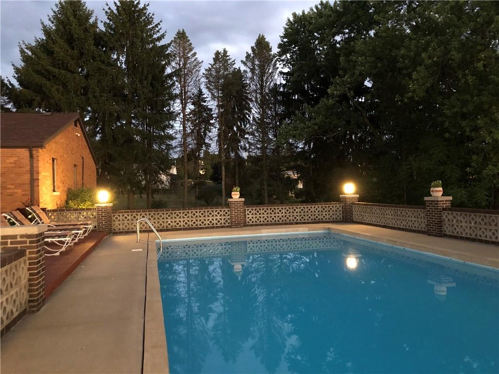 3616 New Texas Road Pittsburgh, PA 15239 - Photo 19 of 25 a view of a swimming pool with an outdoor space and seating area