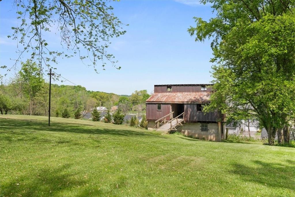3616 New Texas Road Pittsburgh, PA 15239 - Photo 20 of 25 a view of a big yard with table and chairs under an umbrella