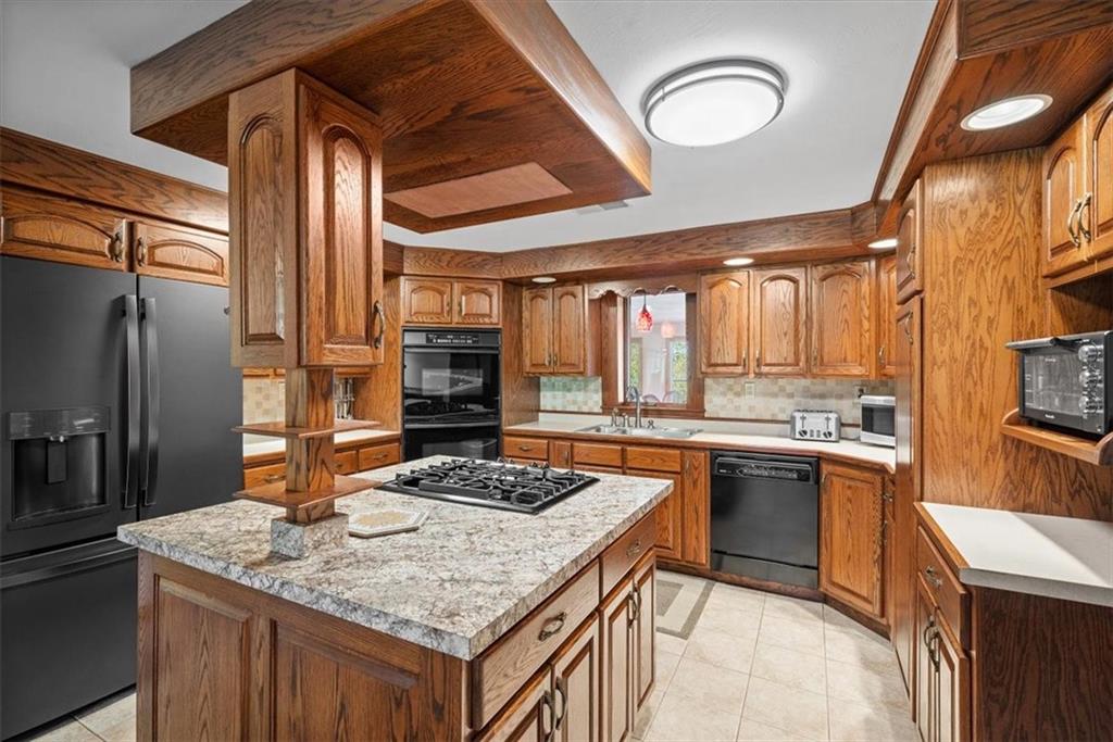 3616 New Texas Road Pittsburgh, PA 15239 - Photo 4 of 25 a kitchen with stainless steel appliances granite countertop a sink a stove and a refrigerator