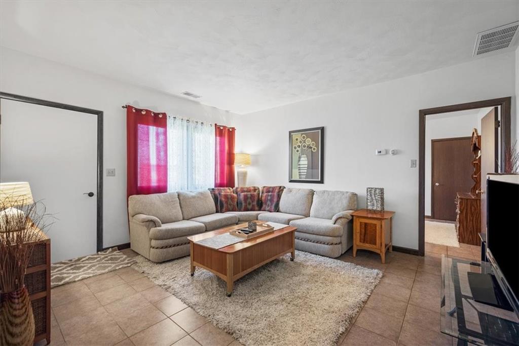 3616 New Texas Road Pittsburgh, PA 15239 - Photo 9 of 25 a living room with furniture a flat screen tv and a window