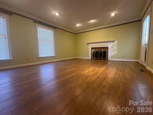 2073 State Rd S-28-522 Bethune, SC 29009 - Photo 8 of 14 an empty room with wooden floor and fireplace