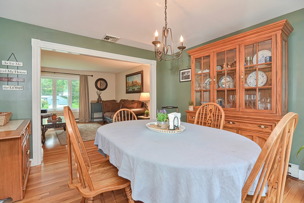 23 Carpenter Road Northbridge, MA 01588 - Photo 15 of 38 a view of a dining room with furniture a chandelier and wooden floor