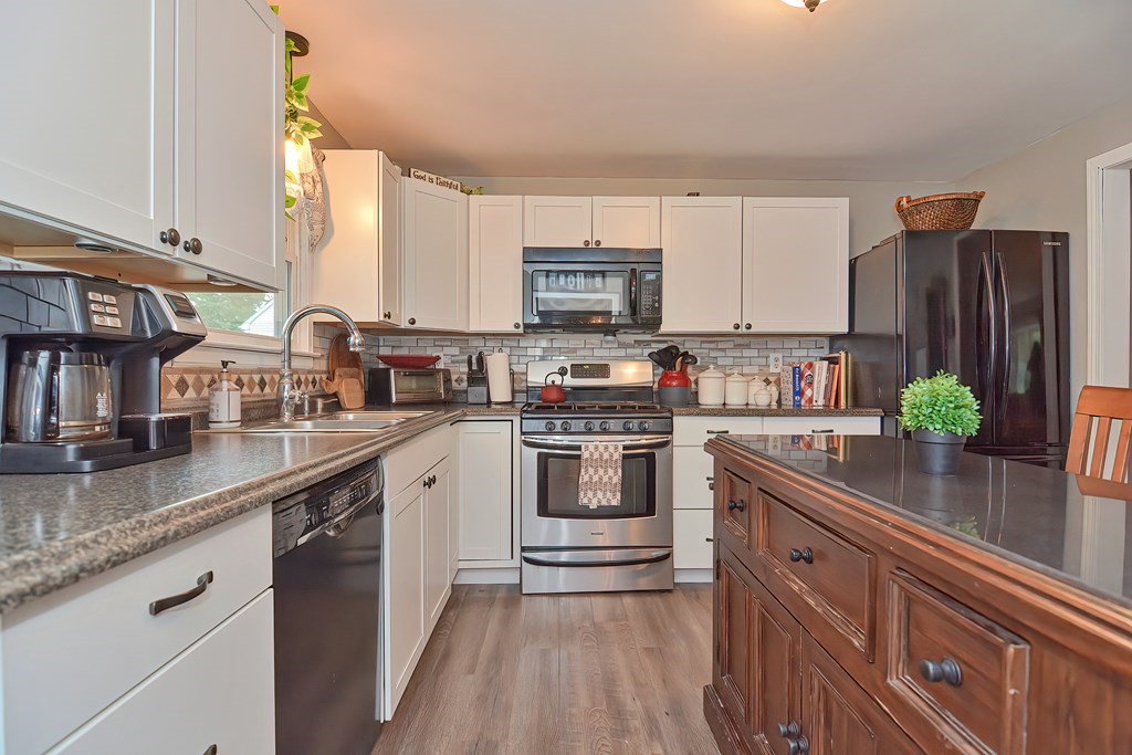 23 Carpenter Road Northbridge, MA 01588 - Photo 16 of 38 a kitchen with stainless steel appliances granite countertop a sink a stove and cabinets