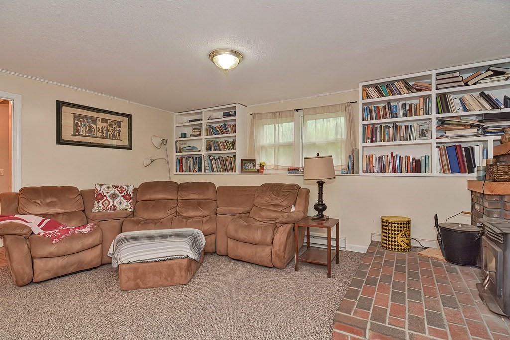 23 Carpenter Road Northbridge, MA 01588 - Photo 30 of 38 a living room with furniture and a book shelf
