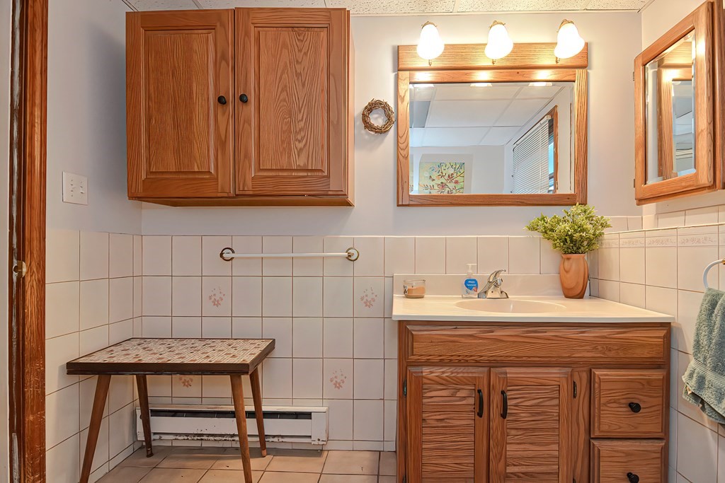 23 Carpenter Road Northbridge, MA 01588 - Photo 38 of 38 a bathroom with a sink and a mirror