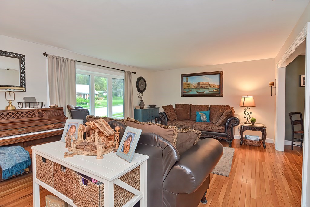 23 Carpenter Road Northbridge, MA 01588 - Photo 8 of 38 a living room with furniture a large window and wooden floor