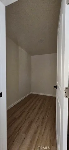 an empty room with wooden floor