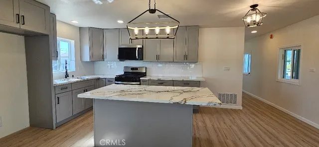 a kitchen with a sink window and cabinets
