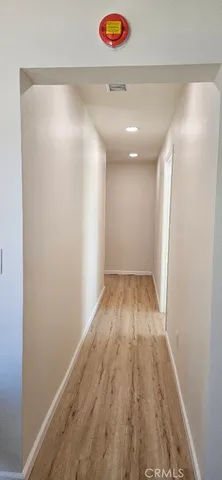 a view of hallway with wooden floor