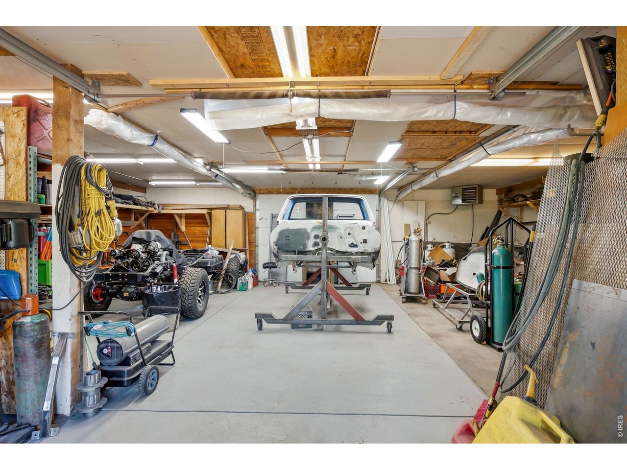 1154 Spring Valley Road Bellvue, CO 80512 - Photo 23 of 31 Insulated garage/shop with concrete floors throughout, two 220 amp outlets and propane heater. Enclosed storage area to the right.