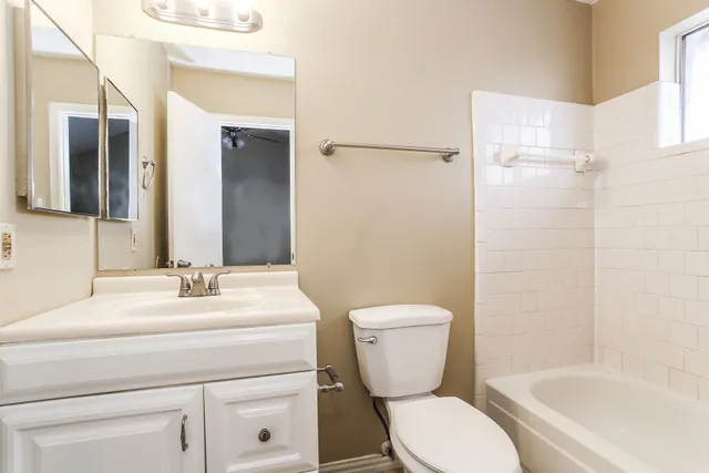 a bathroom with a sink toilet a mirror and shower
