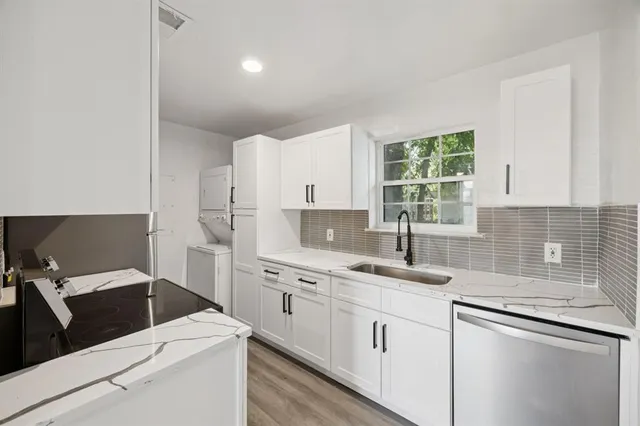 a kitchen with a sink stove and cabinets