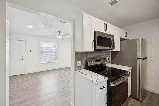 a kitchen with a sink stove and microwave