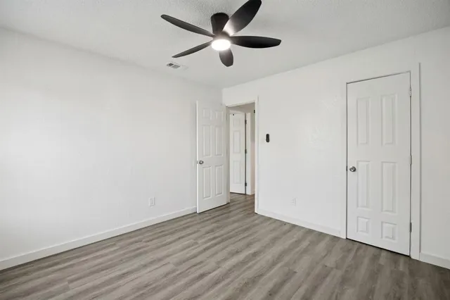 a view of an empty room and wooden floor