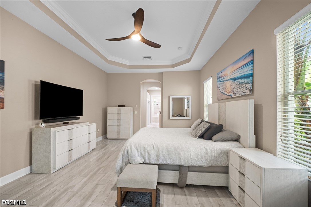 9042 Bronco Court Naples, FL 34113 - Photo 16 of 50 a bedroom with a bed and a flat screen tv
