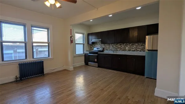 a view of kitchen with microwave and refrigerator