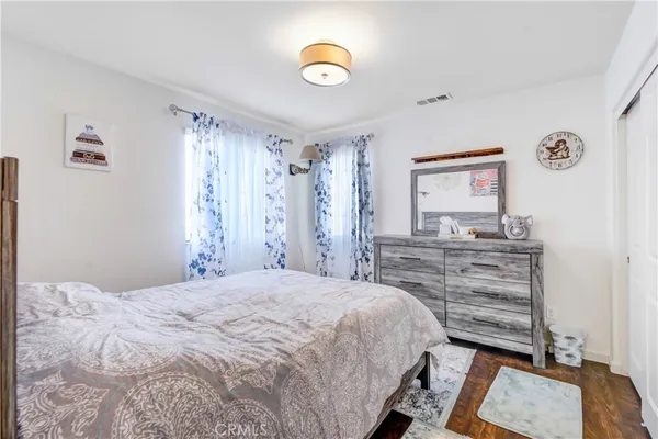 a bedroom with a bed and a dresser