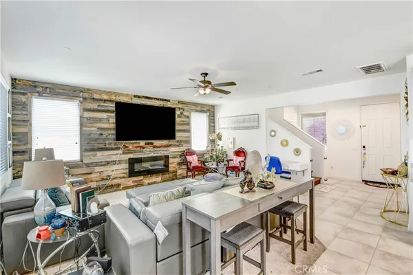 a view of a dining room with furniture and a flat screen tv