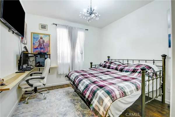 a bedroom with a bed a desk and chair