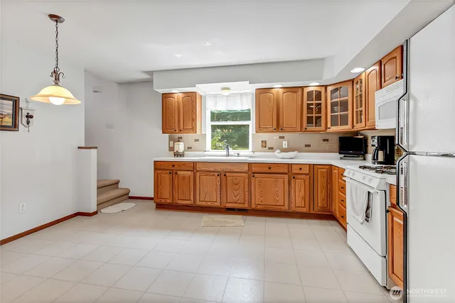 a kitchen with a sink and a stove top oven