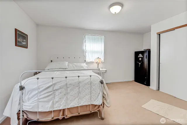 a spacious bedroom with a bed and window