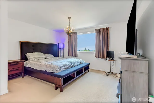 a bedroom with a bed and a flat screen television