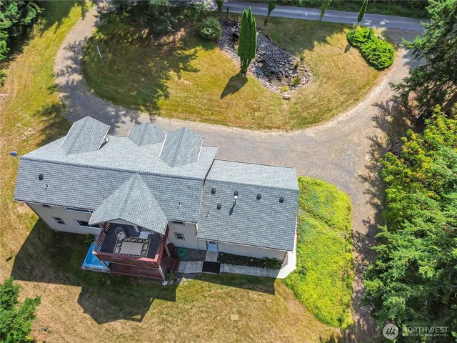 an aerial view of a house with a swimming pool