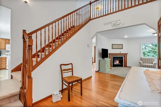a view of a livingroom with an empty kitchen and a fireplace