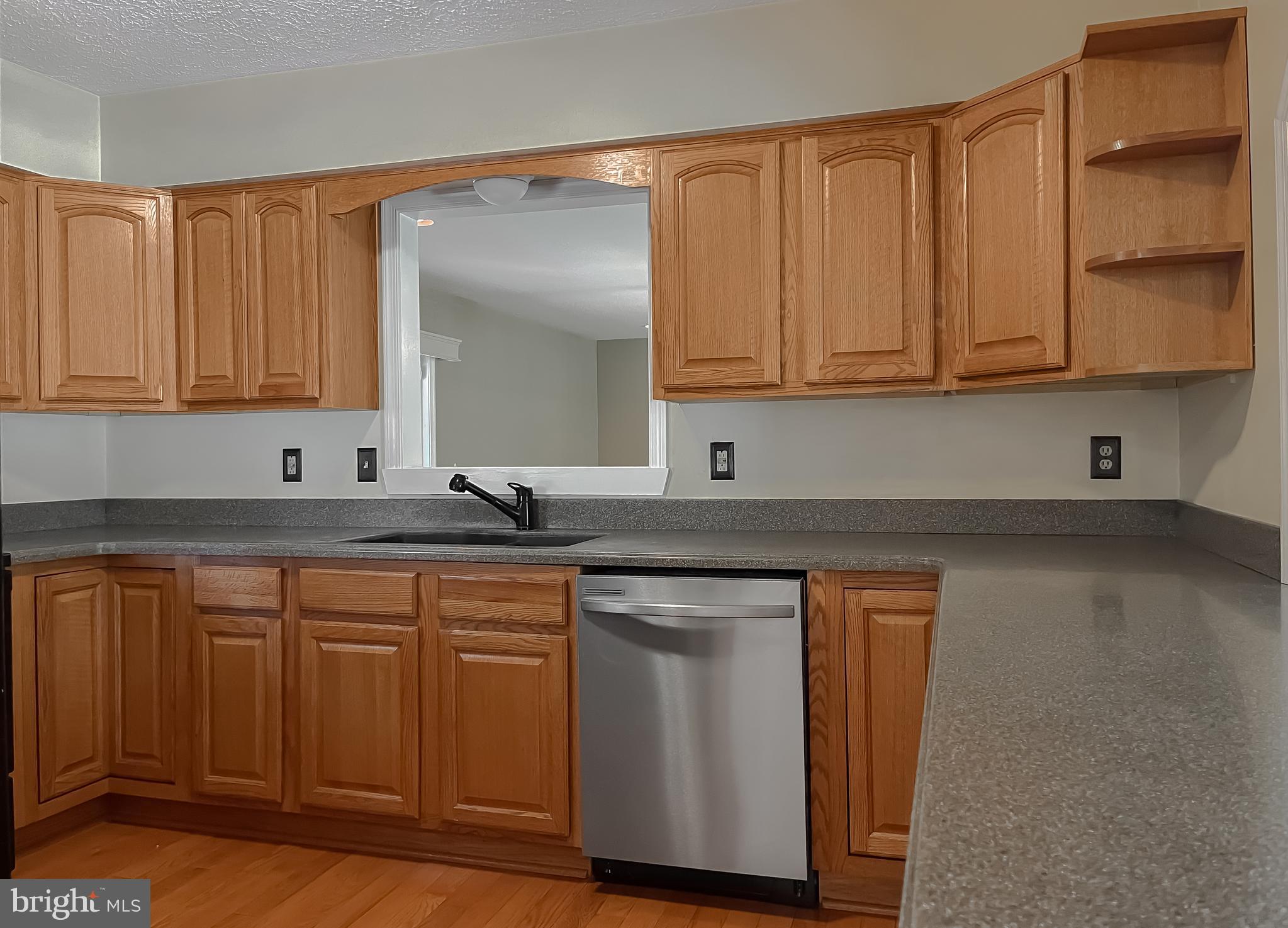 29799 Allen Road Mechanicsville, MD 20659 - Photo 11 of 49 a kitchen with granite countertop wooden cabinets and a sink