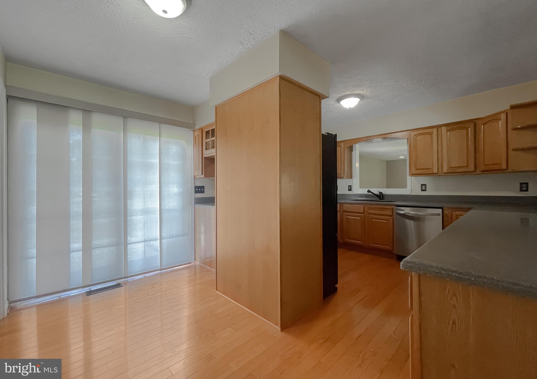 29799 Allen Road Mechanicsville, MD 20659 - Photo 12 of 49 a kitchen with a refrigerator and a sink