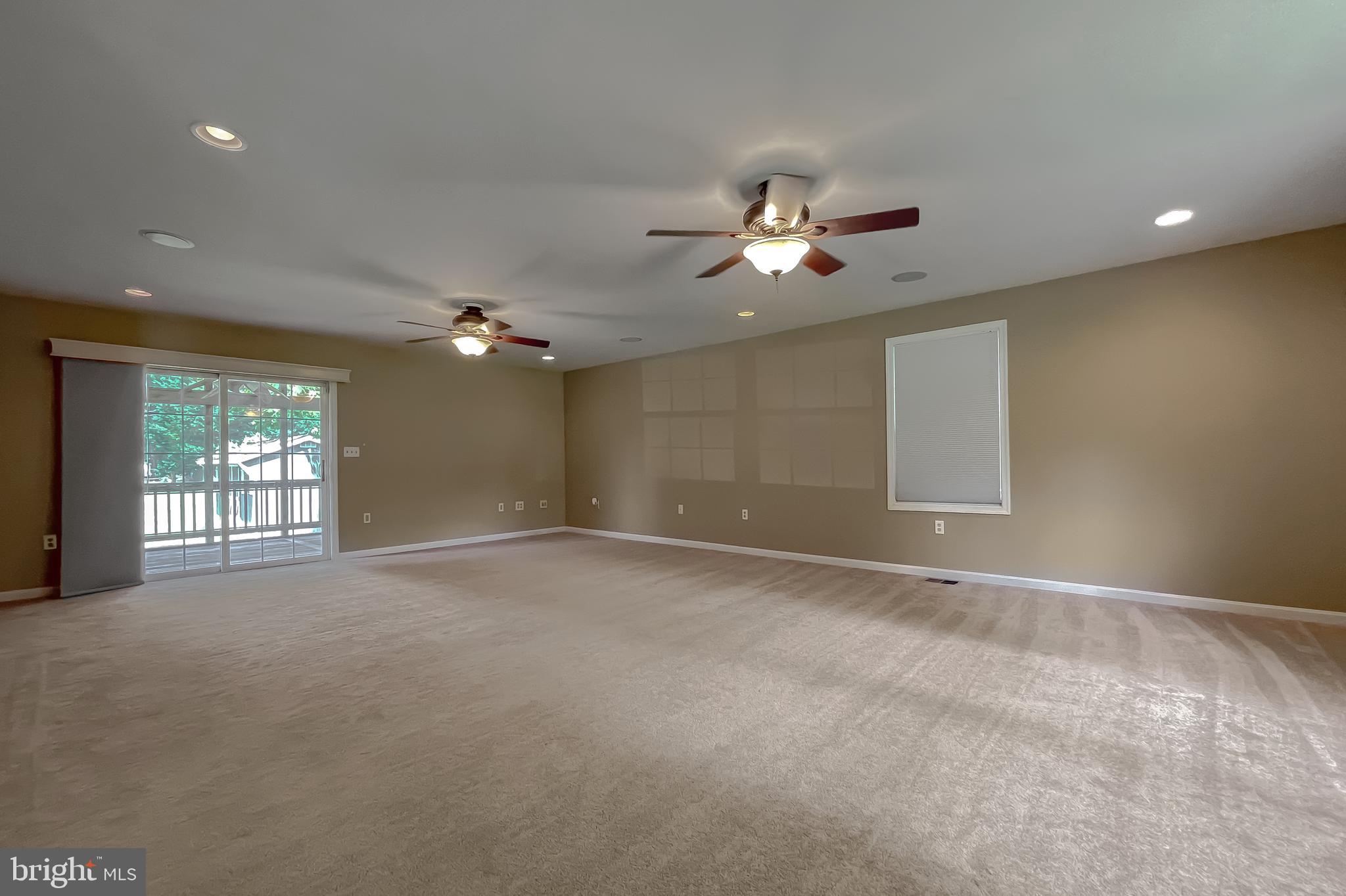 29799 Allen Road Mechanicsville, MD 20659 - Photo 18 of 49 a view of a livingroom with a ceiling fan window and a chandelier
