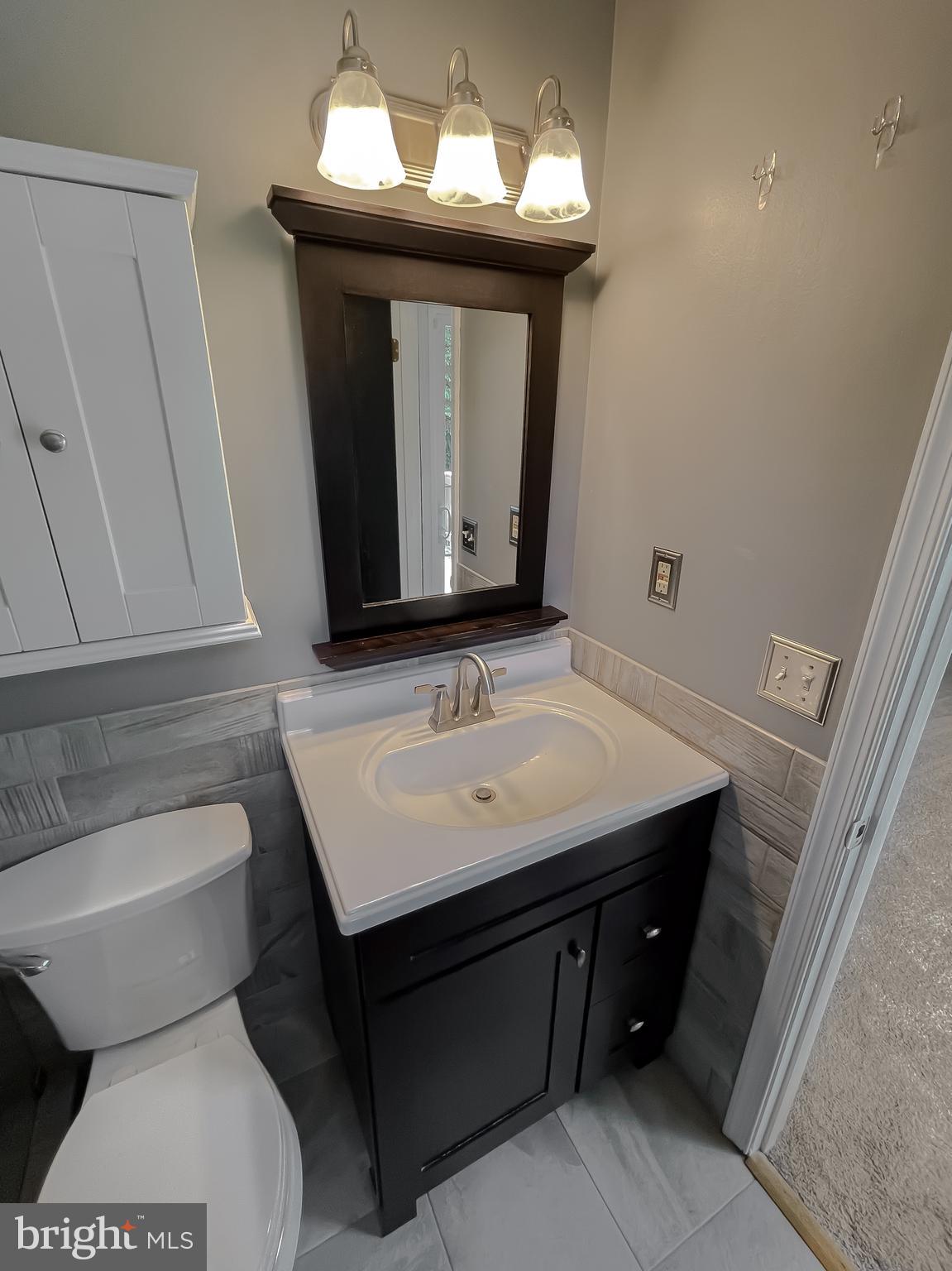 29799 Allen Road Mechanicsville, MD 20659 - Photo 24 of 49 a bathroom with a toilet sink and mirror