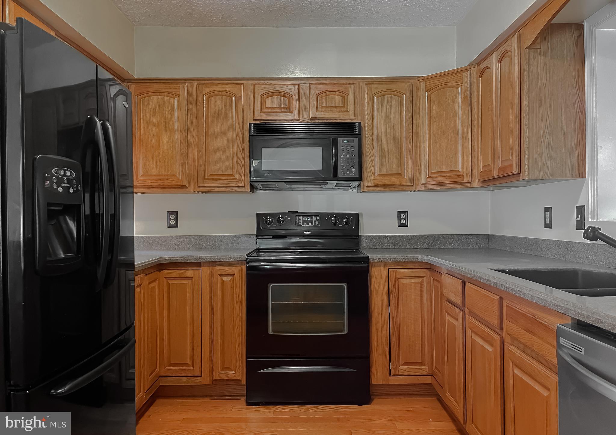 29799 Allen Road Mechanicsville, MD 20659 - Photo 8 of 49 a kitchen with stainless steel appliances granite countertop a stove microwave and refrigerator