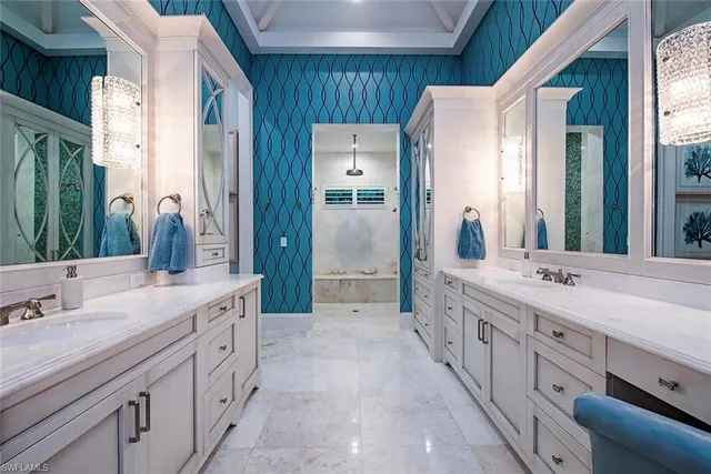 a spacious bathroom with double vanity and mirrors