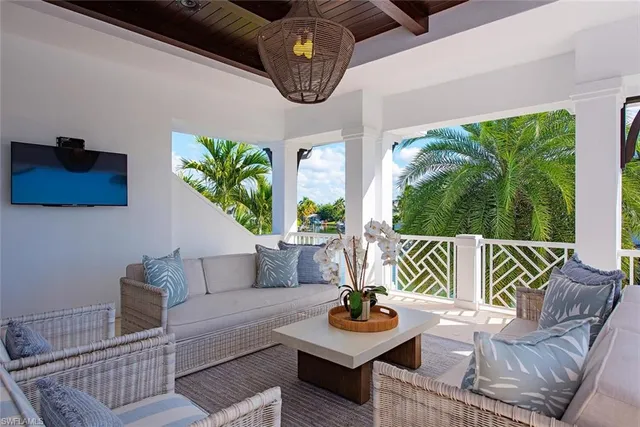 a living room with furniture and a floor to ceiling window