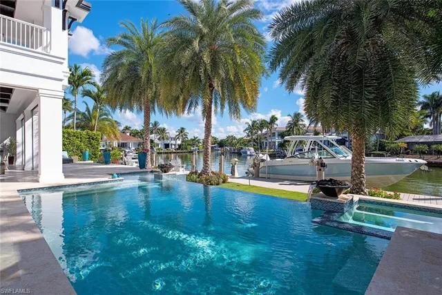 a swimming pool with outdoor seating and yard