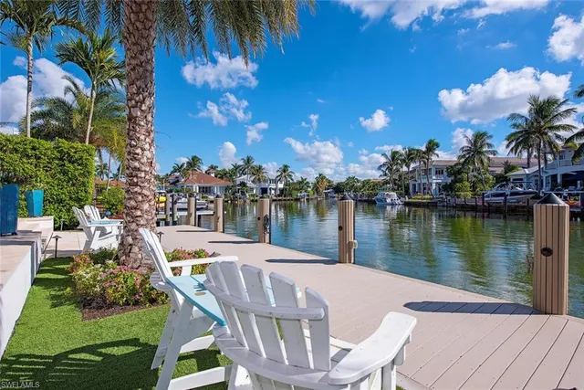 a view of a lake with a table and chairs