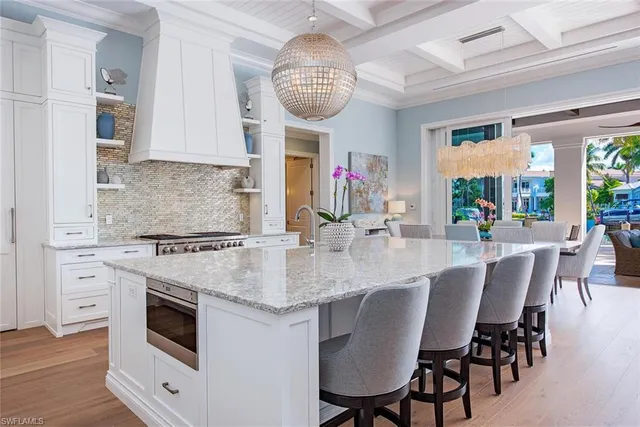 a view of kitchen and dining area with a large window