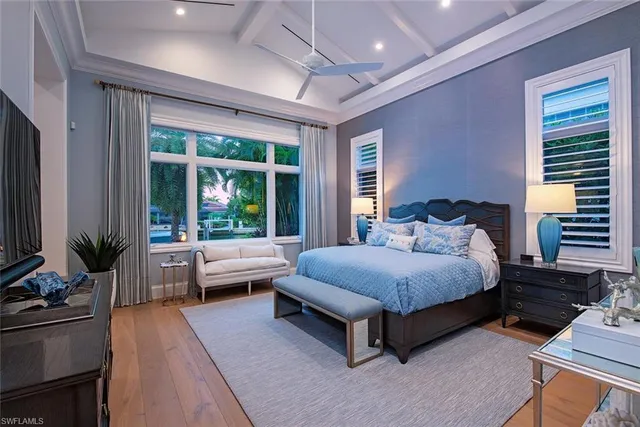 a bedroom with a large bed and a large window