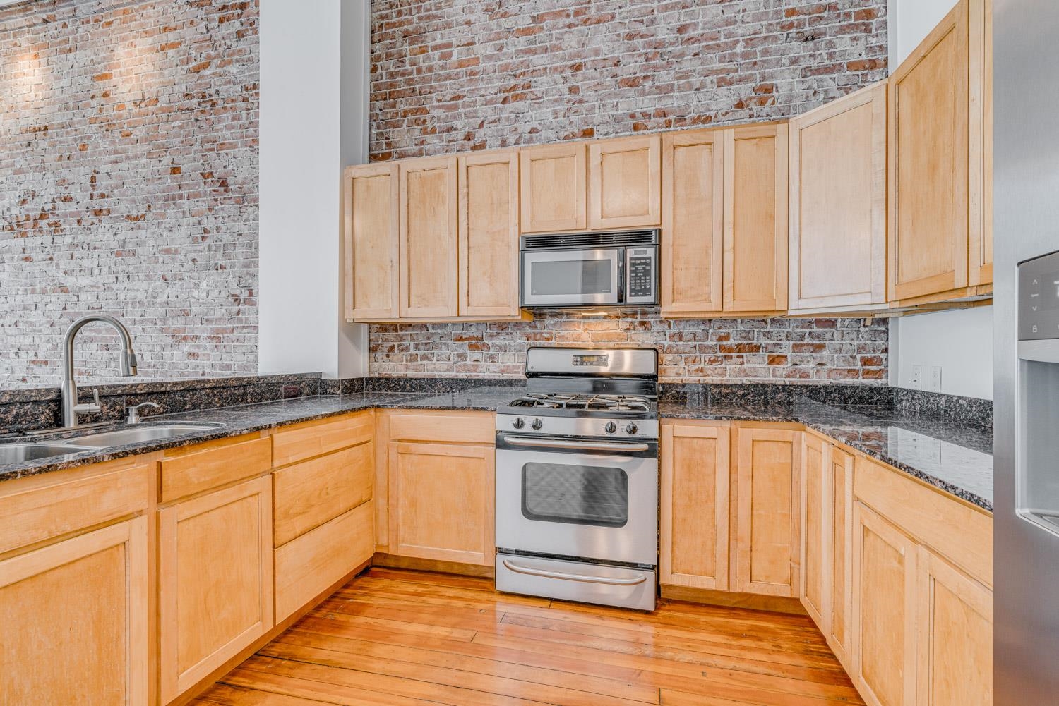 310 South Main Street, Unit 101 Memphis, TN 38103 - Photo 13 of 28 a kitchen with stainless steel appliances granite countertop a stove sink and cabinets