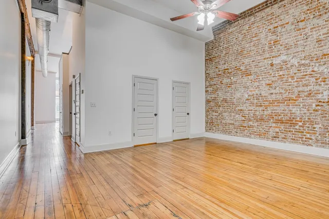 a bathroom with a granite countertop sink a toilet a mirror and shower